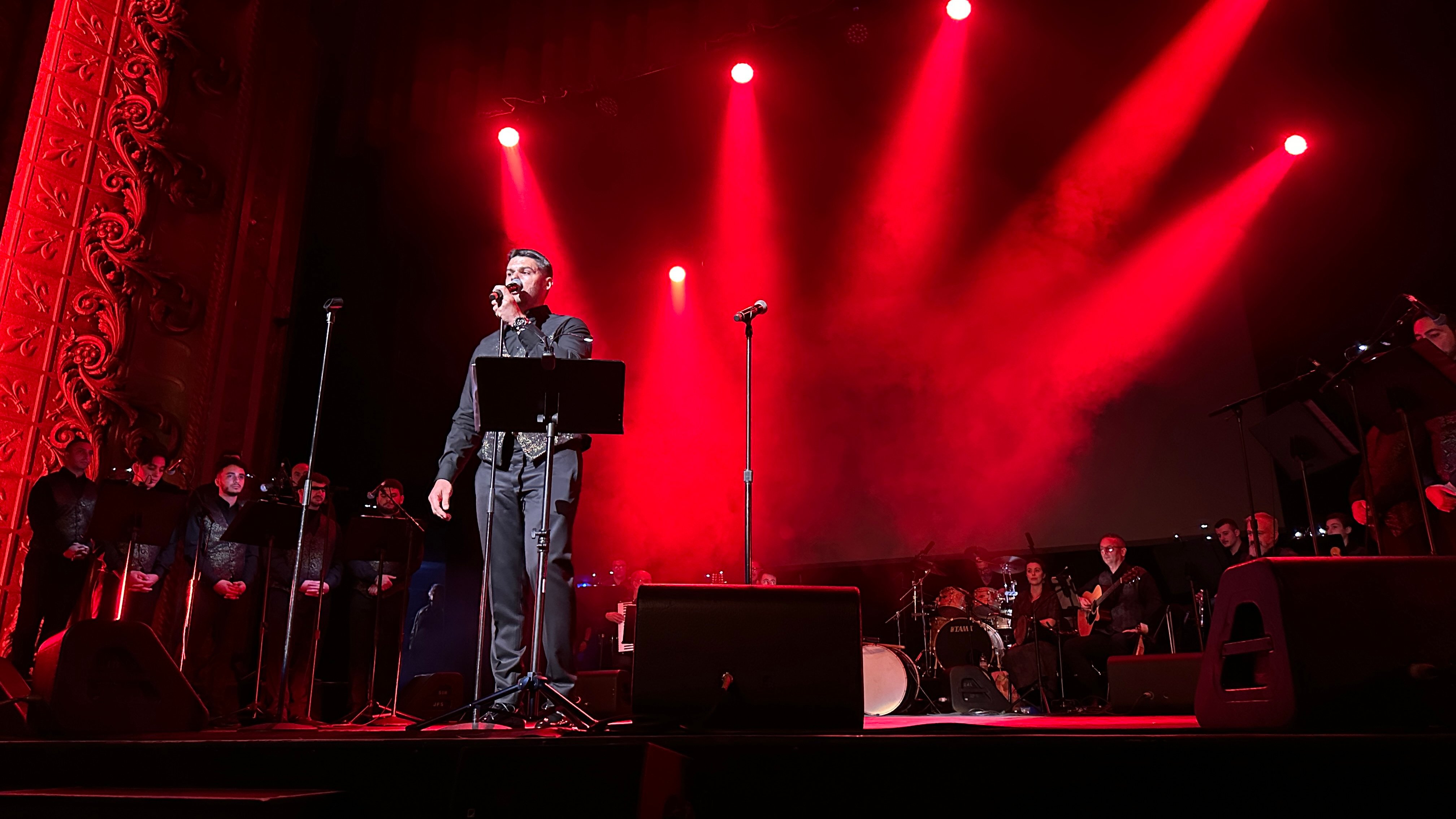Soloist under dramatic red stage lighting