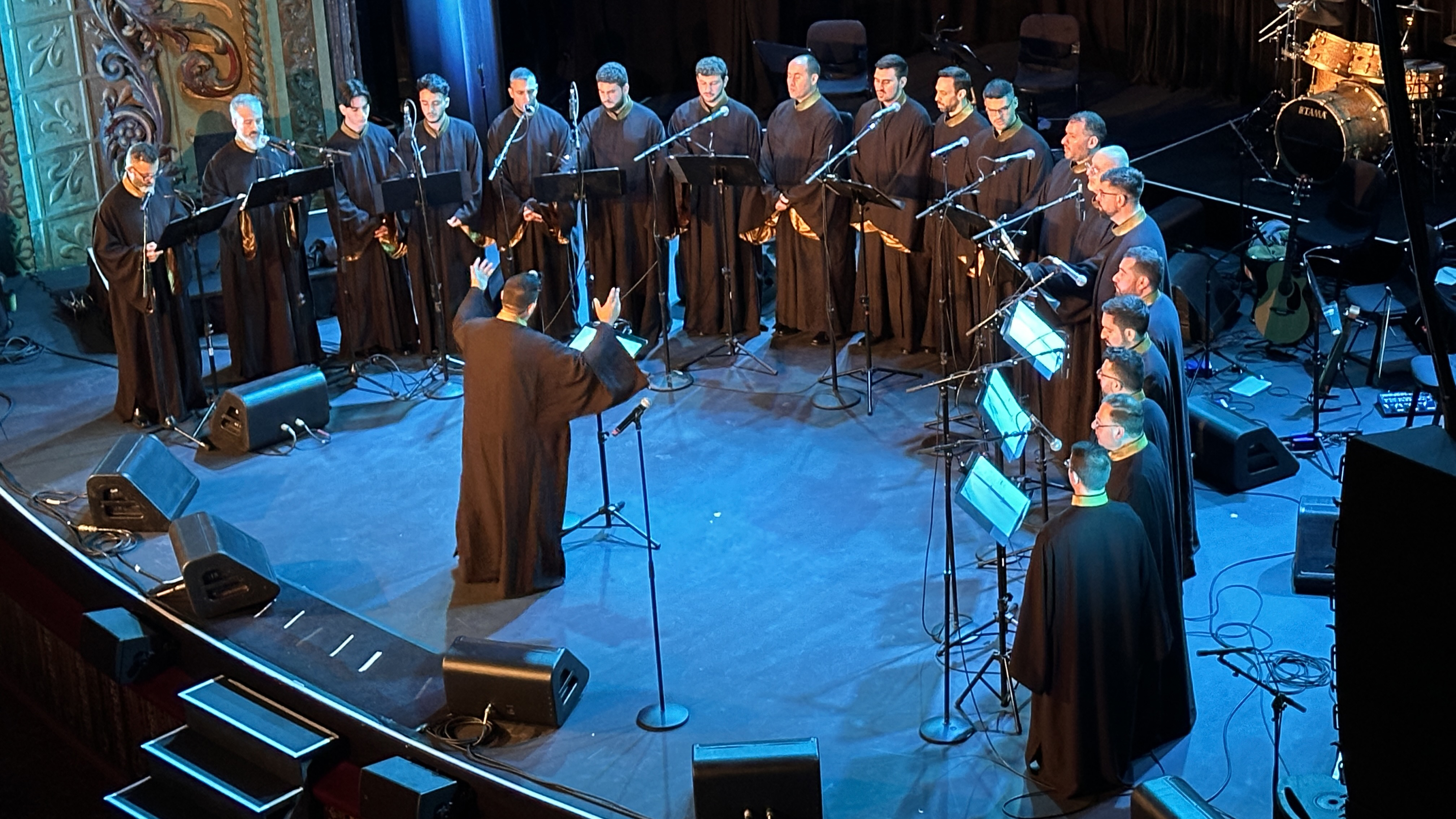 The ensemble in formation on stage